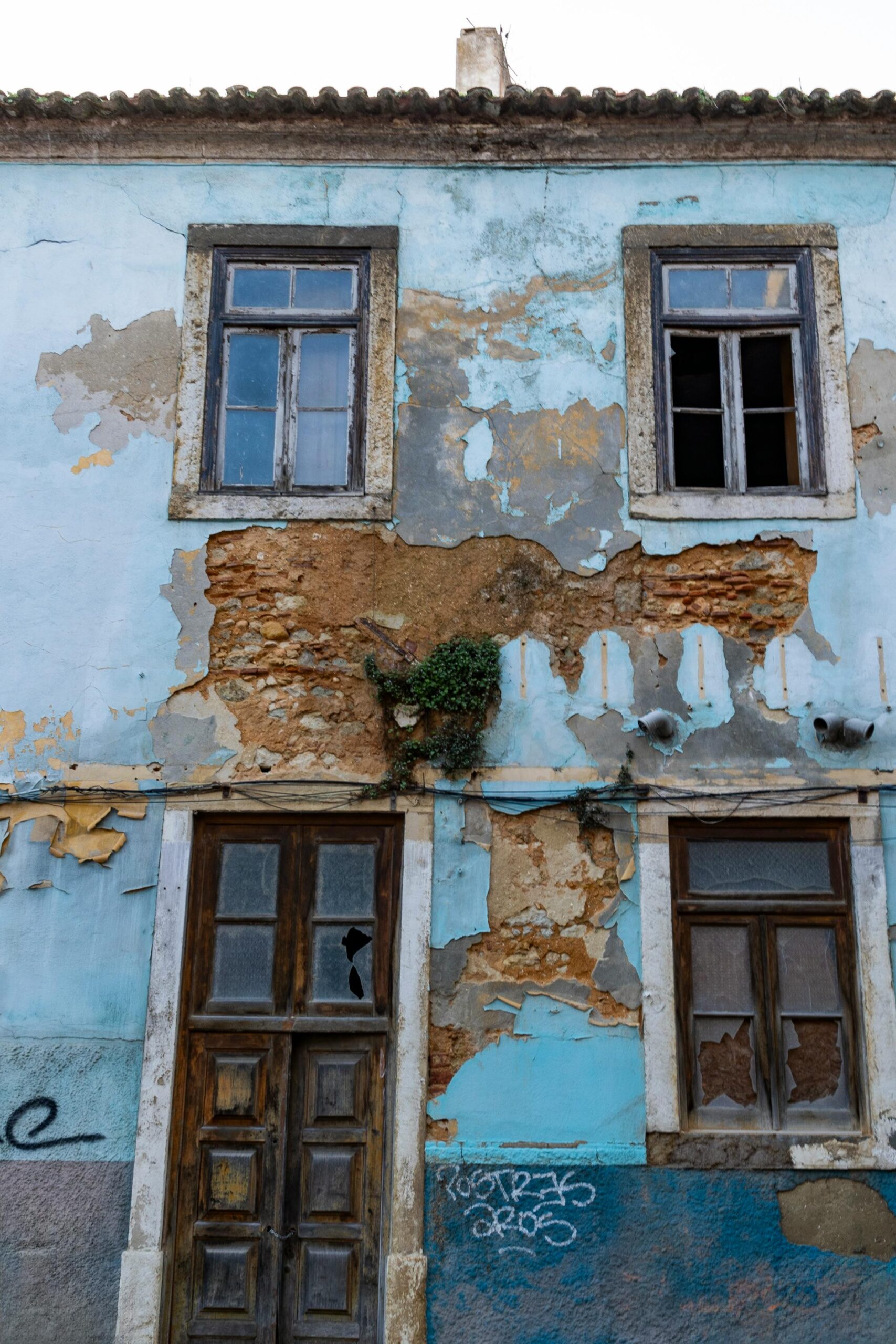 A vintage building facade in Lisbon, Portugal, showcasing aged architecture and wear.